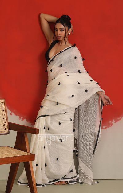 A striking White Linen Saree With woven in Pom Pots