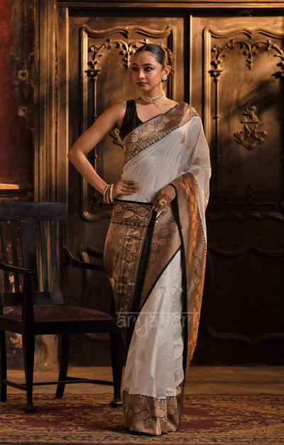 Striking White Katan Silk Saree With A Black Border & Gold Buttas