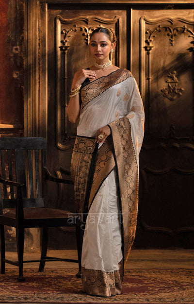 Striking White Katan Silk Saree With A Black Border & Gold Buttas