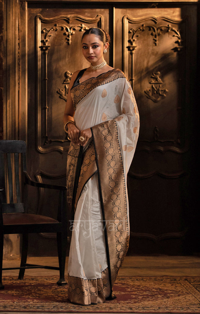 Striking White Katan Silk Saree With A Black Border & Gold Buttas