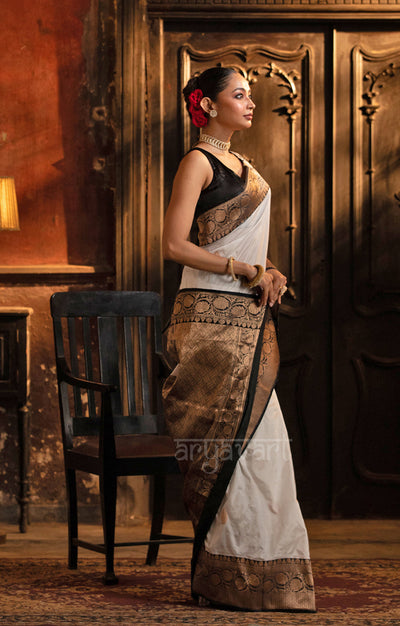 Striking White Katan Silk Saree With A Black Border & Gold Buttas