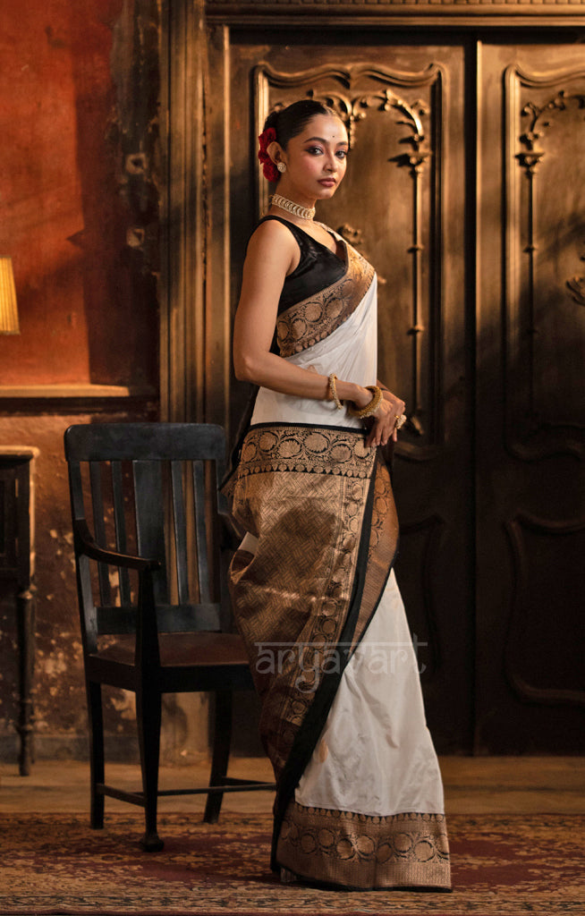 Striking White Katan Silk Saree With A Black Border & Gold Buttas