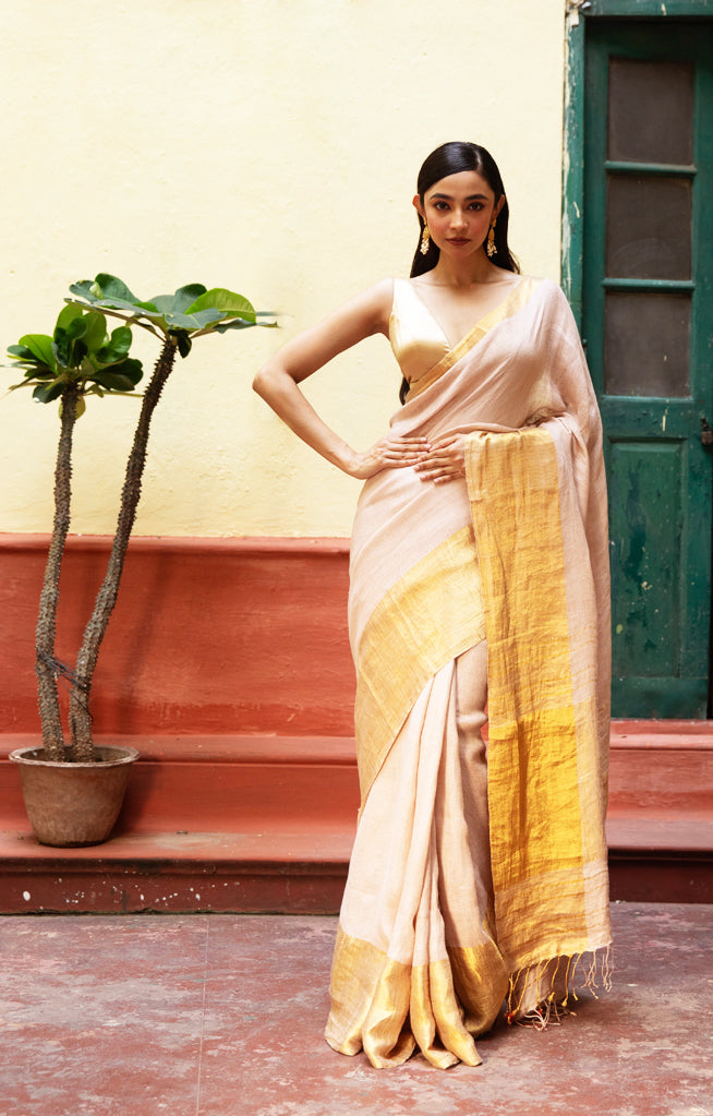 Coral Blossom Textured Linen Saree With A Striking Gold Zari Border & Pallu