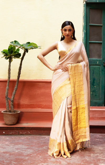 Coral Blossom Textured Linen Saree With A Striking Gold Zari Border & Pallu