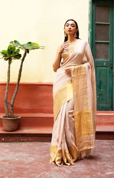 Coral Blossom Textured Linen Saree With A Striking Gold Zari Border & Pallu