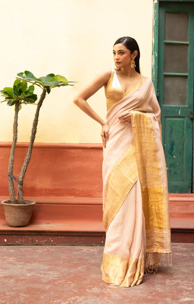 Coral Blossom Textured Linen Saree With A Striking Gold Zari Border & Pallu