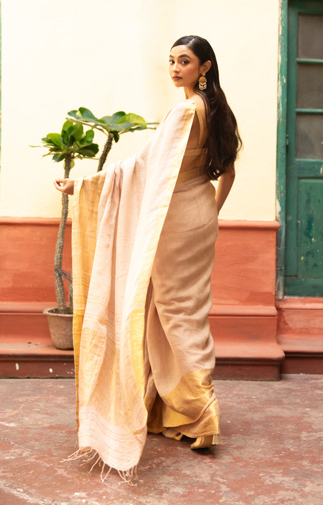 Coral Blossom Textured Linen Saree With A Striking Gold Zari Border & Pallu