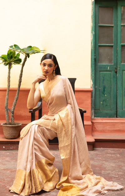 Coral Blossom Textured Linen Saree With A Striking Gold Zari Border & Pallu