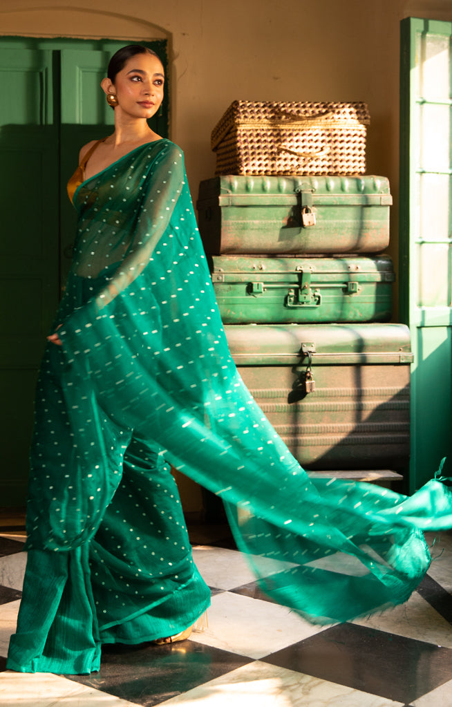 A Vibrant Teal Matka Silk Saree With Woven In Shell Sequence