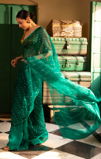 A Vibrant Teal Matka Silk Saree With Woven In Shell Sequence