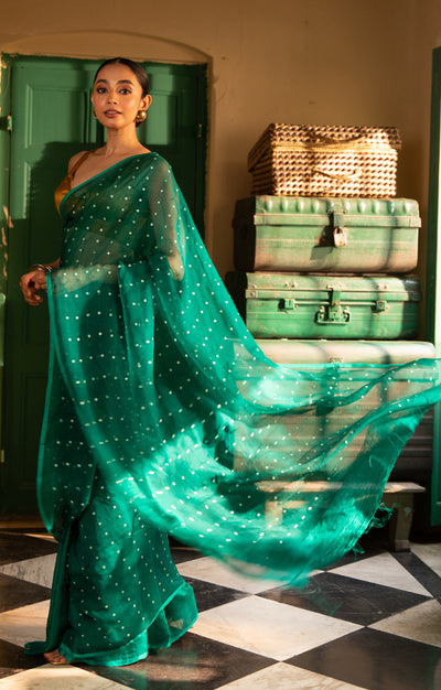 A Vibrant Teal Matka Silk Saree With Woven In Shell Sequence