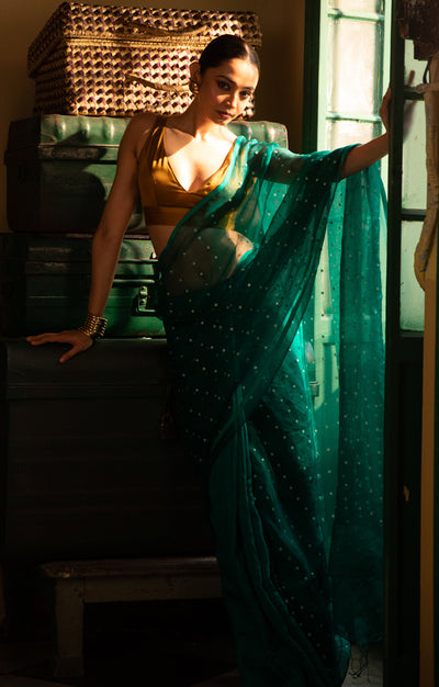 A Vibrant Teal Matka Silk Saree With Woven In Shell Sequence
