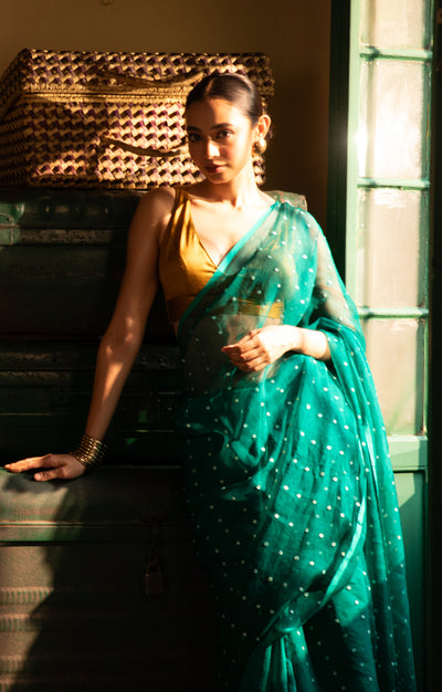 A Vibrant Teal Matka Silk Saree With Woven In Shell Sequence