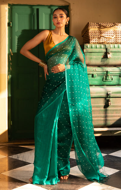 A Vibrant Teal Matka Silk Saree With Woven In Shell Sequence